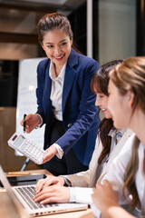 Professional young business woman manager explaining  solutions helping young employee at work.
