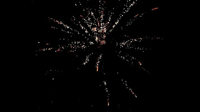 Colorful holiday fireworks bursting in the night sky during a festive celebration