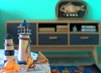 Lighthouses and shells on a table in a room decorated in a nautical style