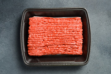 Fresh meat. Mincemeat, minced or ground meat. Meat in a plastic black container from the market....