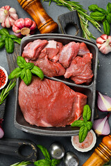 Fresh meat. Raw piece of beef. Meat on a plastic black container from the market. Close-up.