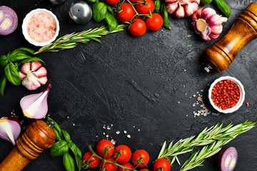 Cooking background. Top view. Spices, vegetables and seasonings on the kitchen table.