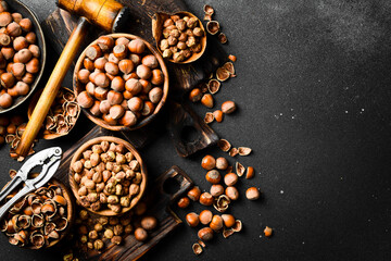 Nuts background. Freshly harvested hazelnut. On a black stone background.