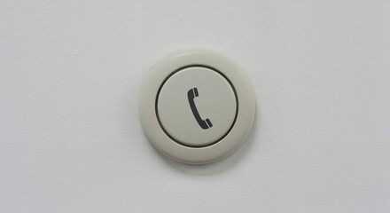 Fototapeta premium Circular hospital call button with a phone symbol on a white background
