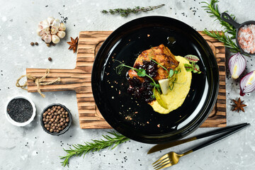 Baked pork steak with cherry sauce and spices. Restaurant menu. Rustic style.