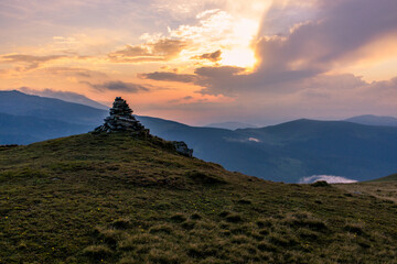 Sunset in the Carpathian Mountains is a magical moment — golden light bathes the peaks, clouds...