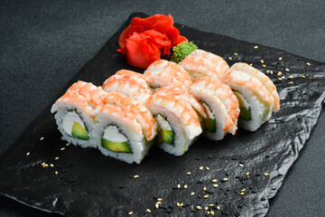 Traditional fresh Japanese sushi rolls with shrimp. Served with wasabi sauce and pickled ginger. Close up.