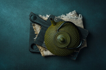 Traditional Japanese teapot for brewing tea. On a black stone background. Top view. Free space for...