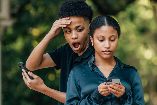 couple spying on cell phone