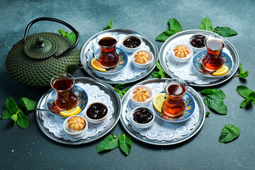 Tea ceremony. Azerbaijani traditional serving of tea. Black tea in a cast iron teapot. Top view.