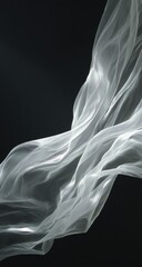 Fototapeta premium Sheer white fabric gracefully flows against a dark backdrop, illuminated by subtle light, creating elegant, flowing curves and translucent textures