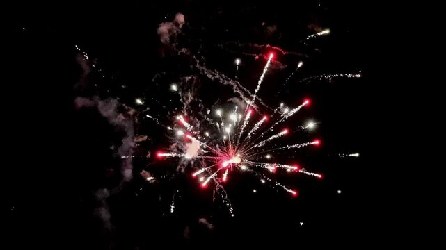 Colorful holiday fireworks bursting in the night sky during a festive celebration