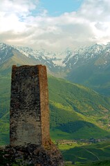 Ancient architecture and ruins against mountain background . Remains of a destroyed tower . North...