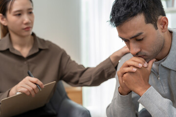psychiatrist holds shoulders while discussing life and family issues. doctor encourages and empathy...