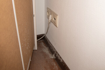 Dust and debris gathering on floor and furniture highlighting need for regular cleaning and home...