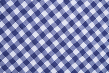 Closeup of a blue and white checkered napkin or tablecloth texture. picnic cloth crumpled. Food decor element. Kitchen accessories. Top view background.