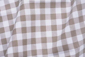 Closeup of a brown and white checkered napkin or tablecloth texture Minimal style. picnic cloth...