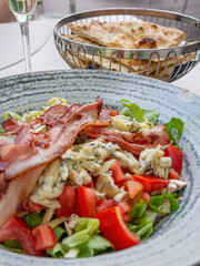 fresh salad with tomatoes, bacon, blue cheese