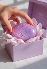 Woman’s Hand Holding Pastel Purple and Pink Glitter Soap in Gift Box