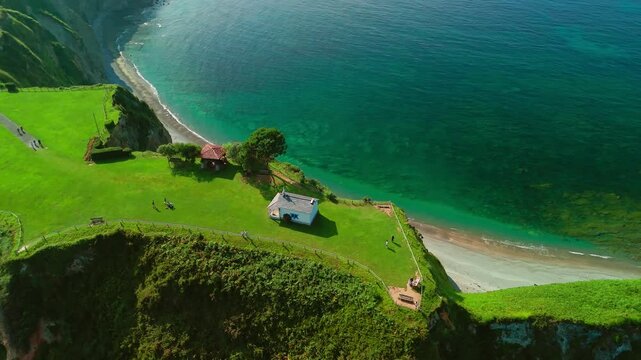 Aerial view of a Ermita de la Regalina on the steep cliffs in Asturias, Spain