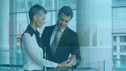 woman swiping smartphone to colleague at glass balcony railing, studying animated financial charts - Powered by Adobe