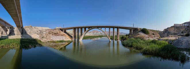 Nallihan Bird Sanctuary Ankara Turkiye  Panoramic View of a Modern Arch Bridge Spanning a River. A wide-angle, panoramic shot of a modern arch bridge gracefully spanning a calm river.