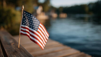American flag on wooden pier by tranquil lake at golden hour
