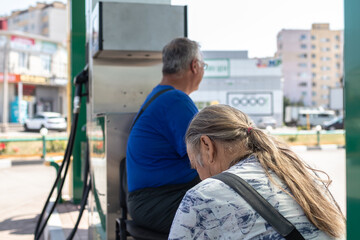 Gas station workers sit and rest during a break