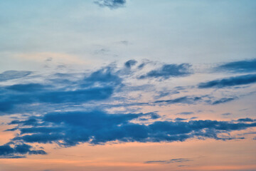 Western sky at sunset. A relaxing scene of day's end with gentle clouds stretching across the...