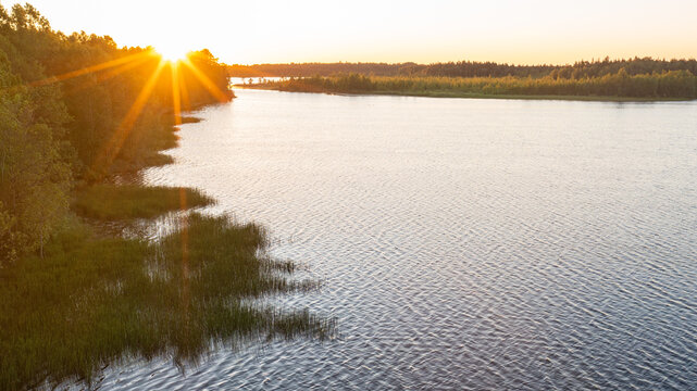 Aerial summer landscape view of a beautiful Jarlepa (J&auml;rlepa) Lake during a vibrant sunset. Located in Rapla County, Estonia
