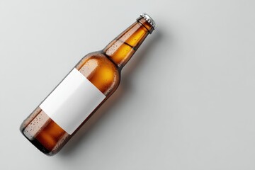 Amber glass beer bottle with blank label, condensation, angled on light grey background