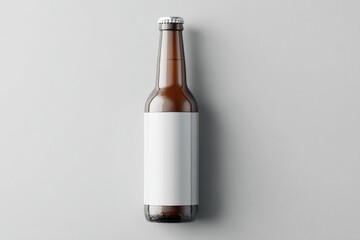Amber glass bottle with blank white label, overhead studio shot on light grey background