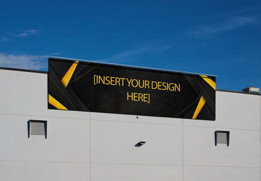 A large horizontal billboard is mounted on a storefront building against a clear blue sky. PSD template mockup