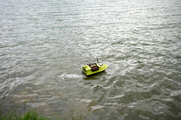 Bait Boat on Water Delivering Fish Feed &ndash; Carp Fishing Equipment