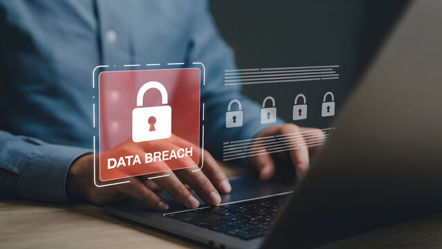 Person is working on laptop with a data breach alert, emphasizing cybersecurity concerns, privacy protection, and the risk of security incident with sensitive information.
