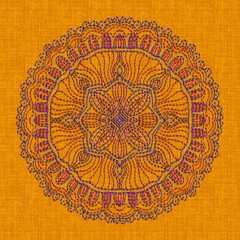Intricate mandala floral embroidery on golden yellow fabric background, evoking warmth and handcrafted artistry.