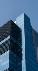 Obraz premium Architectural Marvel: Modern Building Design with Glass Facade, Reflections of Urban Grandeur: A Contemporary Glass Skyscraper