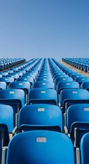 Fototapeta premium Rows of Empty Blue Stadium Seats Under a Clear Blue Sky, Endless Rows of Bright Blue Seats in a Large Outdoor Stadium
