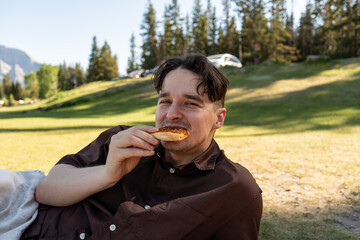 Man smiling while holding pizza