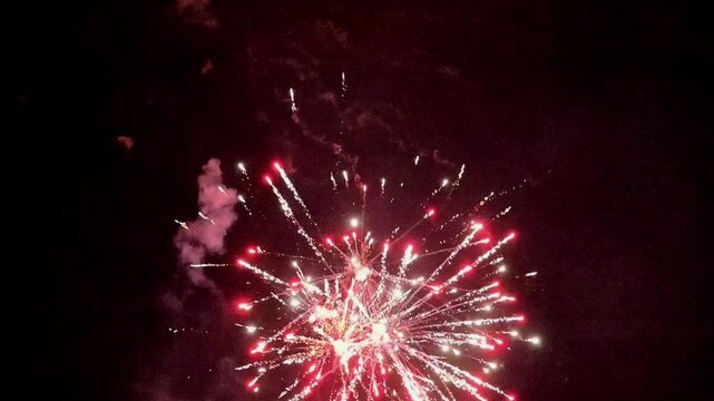 Colorful holiday fireworks bursting in the night sky during a festive celebration