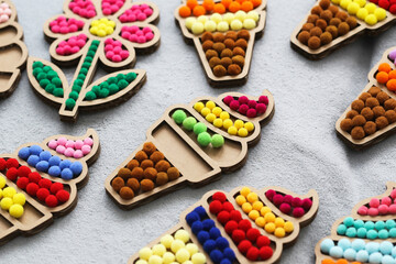 Colorful sensory craft for kids. Cardboard base with soft felt balls. Ice cream and flower shapes....