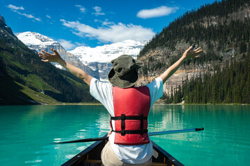 Canoe on mountain lake with person