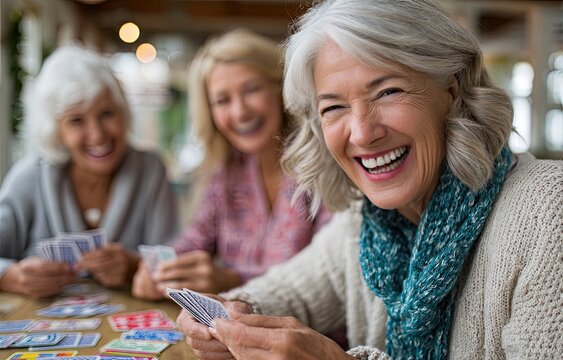 Elderly women playing board games in the living room of an old people's home, laughing and having fun together, a sense of community, happy faces