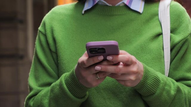 Tourist walking on the street on sunny day, relaxing using phone, chatting with friends, scrolling social media. High quality 4k footage