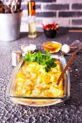 Fried cauliflower with eggs in baking dish. Space for text.