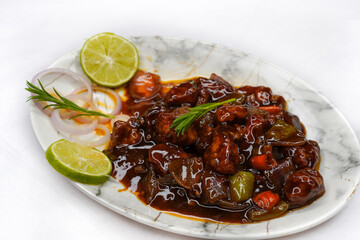 Chilli chicken, Korean style fried chili chicken made at home in India, Serve on a plate over white background