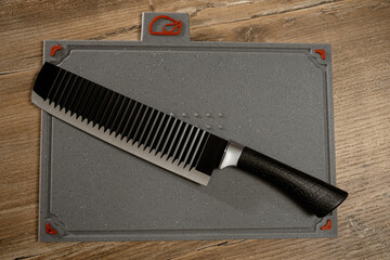 Perfectly sharpened knife rests on a textured cutting board ready for culinary adventures in a cozy...