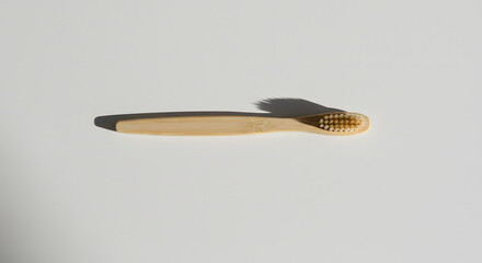 Modern top view of a single wooden spoon on white surface with soft edge lighting for product or culinary use