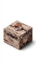 A rose gold solitaire diamond ring rests inside a rustic, square, wood grain ring box