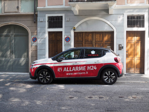 White Citroen C3 Aircross compact crossover parking illegally beside signposted urban building, red trimmed compact SUV model